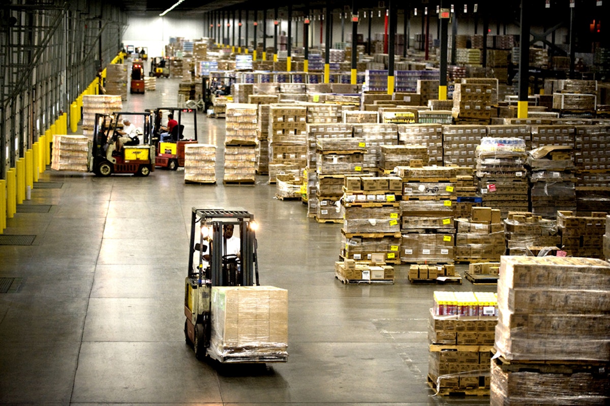 Machine carrying boxes in a warehouse. 4 Ways to Increase the Energy Efficiency of Your Warehouse This Winter