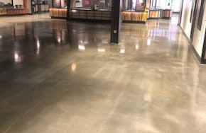 A facility floor after concrete polishing and restoration How Concrete Polishing and Restoration Mitigates Dust and Adds Strength and Longevity