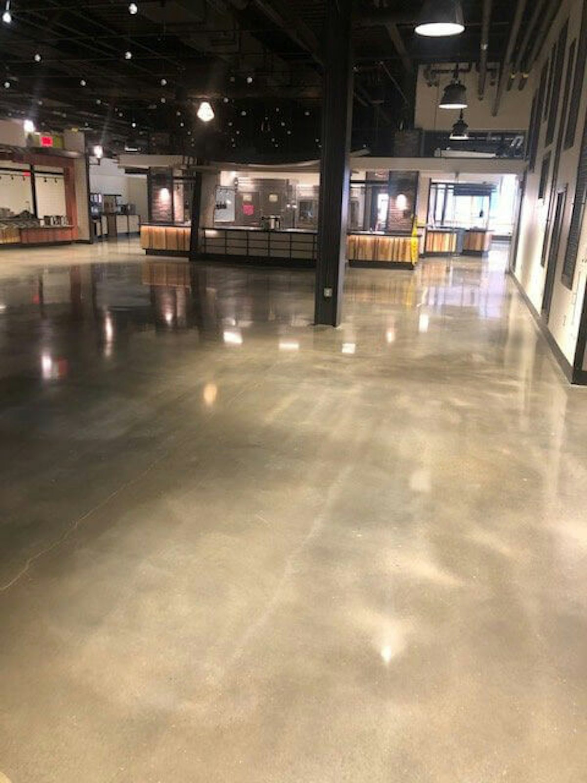 A facility floor after concrete polishing and restoration How Concrete Polishing and Restoration Mitigates Dust and Adds Strength and Longevity