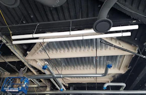 Spray on fireproofing on an industrial ceiling. Why the Flexibility of Spray Fireproofing Is Essential for Full Coverage and Code Compliance